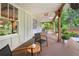 Inviting covered porch with comfortable seating and view of landscaped yard, perfect for relaxation and enjoying the outdoors at 2020 New Kemp Rd, Marietta, GA 30066