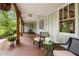 Charming covered porch with stylish seating, decorative lighting, and views of the lush, landscaped surroundings at 2020 New Kemp Rd, Marietta, GA 30066