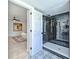 Tiled walk-in shower features a glass enclosure, black hardware and modern fixtures at 259 Tarragon Sw Way, Atlanta, GA 30331