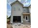 Two-story home with open garage, showcasing modern design and curb appeal at 31 Benscot Dr, Austell, GA 30106