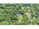 Aerial view showcasing home nestled among mature trees with lush landscaping at 386 Link Rd, Alpharetta, GA 30022