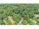 Aerial view showcasing home nestled among mature trees and lush landscaping at 386 Link Rd, Alpharetta, GA 30022