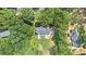 Aerial view showcasing home's backyard featuring stone patio, screened porch, lush lawn, and mature trees at 386 Link Rd, Alpharetta, GA 30022