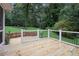 Wooden deck with stone retaining wall overlooking the green backyard at 386 Link Rd, Alpharetta, GA 30022