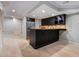 Finished basement with black wet bar and stainless steel refrigerator, perfect for entertaining guests at 386 Link Rd, Alpharetta, GA 30022