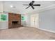 Basement living room featuring a brick fireplace, windows, and french doors leading to the outside at 386 Link Rd, Alpharetta, GA 30022