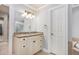 Bathroom with granite vanity and cabinetry, framed mirror, and walk-in closet access at 386 Link Rd, Alpharetta, GA 30022