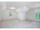 Bright bedroom featuring neutral carpet, dormer window, and a closet door at 386 Link Rd, Alpharetta, GA 30022
