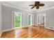 Bedroom featuring hardwood floors, white trim, ceiling fan, and windows with shutter-style blinds at 386 Link Rd, Alpharetta, GA 30022