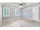 Bedroom with neutral carpet, ceiling fan, and natural light from two windows at 386 Link Rd, Alpharetta, GA 30022