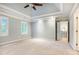 Spacious bedroom featuring tray ceiling, ceiling fan, and bright natural light at 386 Link Rd, Alpharetta, GA 30022
