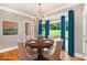 Elegant dining room featuring hardwood floors, large window, chandelier, and designer window treatments at 386 Link Rd, Alpharetta, GA 30022