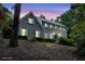 Charming two-story brick home with gray siding, white shutters, and mature landscaping at sunset at 386 Link Rd, Alpharetta, GA 30022