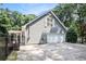 View of the two-car garage with automatic door, side entrance, and manicured yard at 386 Link Rd, Alpharetta, GA 30022