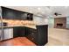 Kitchenette featuring stainless steel appliances, dark cabinetry, and adjacent to a living area with fireplace at 386 Link Rd, Alpharetta, GA 30022
