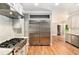 Elegant kitchen with stainless steel appliances, hardwood floors, and access to living spaces at 386 Link Rd, Alpharetta, GA 30022