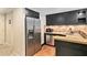 Kitchenette featuring stainless steel appliances, dark cabinetry, and stone countertops at 386 Link Rd, Alpharetta, GA 30022