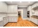 Beautiful kitchen with white cabinets, stainless steel appliances, and a marble backsplash at 386 Link Rd, Alpharetta, GA 30022