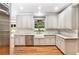 Modern kitchen featuring white cabinets, stainless steel appliances, and hardwood floors at 386 Link Rd, Alpharetta, GA 30022