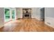 Spacious living room featuring a stone fireplace, built-in bookshelves, and hardwood floors at 386 Link Rd, Alpharetta, GA 30022