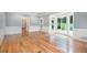Large living room with hardwood floors, white wainscoting, and french doors to the deck at 386 Link Rd, Alpharetta, GA 30022