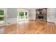 Bright living room with hardwood floors and a stone fireplace flanked by built-in shelving at 386 Link Rd, Alpharetta, GA 30022