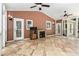 Spacious screened porch with stone fireplace, vaulted ceiling, and fan with tiled floor at 386 Link Rd, Alpharetta, GA 30022