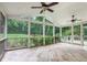 Bright screened porch featuring two ceiling fans and views of the lush backyard at 386 Link Rd, Alpharetta, GA 30022