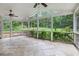 Large screened porch with ceiling fans overlooking a beautifully landscaped backyard at 386 Link Rd, Alpharetta, GA 30022