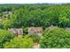 An aerial shot of a beautiful home nestled among mature trees, showcasing a serene and private setting at 11280 Brookhollow Trl, Alpharetta, GA 30022