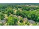 An aerial view showcases a residential neighborhood, dotted with mature trees, offering a serene and suburban landscape at 11280 Brookhollow Trl, Alpharetta, GA 30022