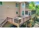 Spacious wooden deck with a grill, stairs to the yard, and a screened porch above at 11280 Brookhollow Trl, Alpharetta, GA 30022