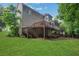 A spacious backyard with a wooden deck and stairs leading down to a lower patio area at 11280 Brookhollow Trl, Alpharetta, GA 30022