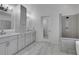 Beautiful bathroom featuring dual vanities and a stylish shower with gray subway tile at 11280 Brookhollow Trl, Alpharetta, GA 30022