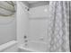 Bright bathroom features a white shower and tub, and a modern patterned shower curtain at 11280 Brookhollow Trl, Alpharetta, GA 30022