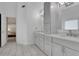 Bright bathroom features a double vanity with light gray cabinets and quartz countertops at 11280 Brookhollow Trl, Alpharetta, GA 30022