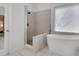 Stylish bathroom showcasing a modern tub and shower with tasteful tiling and design at 11280 Brookhollow Trl, Alpharetta, GA 30022