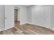 Bedroom offers wood flooring, a window, and closet space at 11280 Brookhollow Trl, Alpharetta, GA 30022