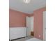 Bedroom with a white dresser and salmon paint on the walls at 11280 Brookhollow Trl, Alpharetta, GA 30022