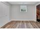 Empty bedroom features wood flooring, a window, and a double door closet at 11280 Brookhollow Trl, Alpharetta, GA 30022