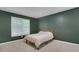 Bedroom with a comfortable bed and natural light streaming through the window at 11280 Brookhollow Trl, Alpharetta, GA 30022