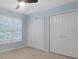 Bedroom featuring a ceiling fan, closet, and bright natural light from the window at 11280 Brookhollow Trl, Alpharetta, GA 30022