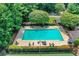 Aerial view of a large, fenced community pool with lounge chairs and umbrellas at 11280 Brookhollow Trl, Alpharetta, GA 30022
