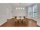 Bright dining room features hardwood floors, natural light from the large windows, and modern chandelier at 11280 Brookhollow Trl, Alpharetta, GA 30022