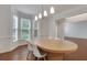 A spacious dining room with natural light streaming through the windows, enhancing the elegant hardwood floors at 11280 Brookhollow Trl, Alpharetta, GA 30022