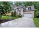 Exterior view of this beautiful stucco home with a wide driveway and well-maintained landscaping at 11280 Brookhollow Trl, Alpharetta, GA 30022