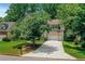 Inviting home with well-maintained lawn, mature trees, and a driveway featuring a basketball hoop at 11280 Brookhollow Trl, Alpharetta, GA 30022