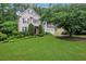 Charming two-story home featuring a well-manicured lawn and mature landscaping providing great curb appeal at 11280 Brookhollow Trl, Alpharetta, GA 30022