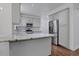Modern kitchen with stainless steel appliances, granite counters, and wooden floors at 11280 Brookhollow Trl, Alpharetta, GA 30022
