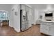 Open kitchen with stainless steel fridge, island with granite countertop, and access to dining area at 11280 Brookhollow Trl, Alpharetta, GA 30022